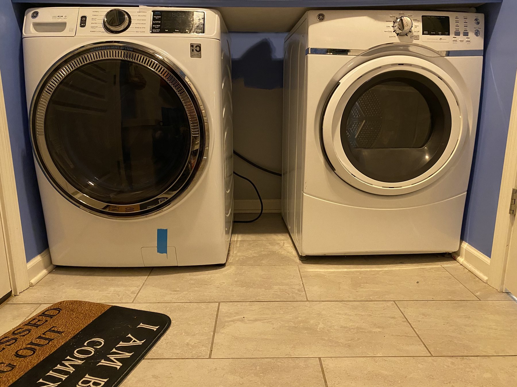 Front-loading washer and dryer installed side by side in a home laundry closet